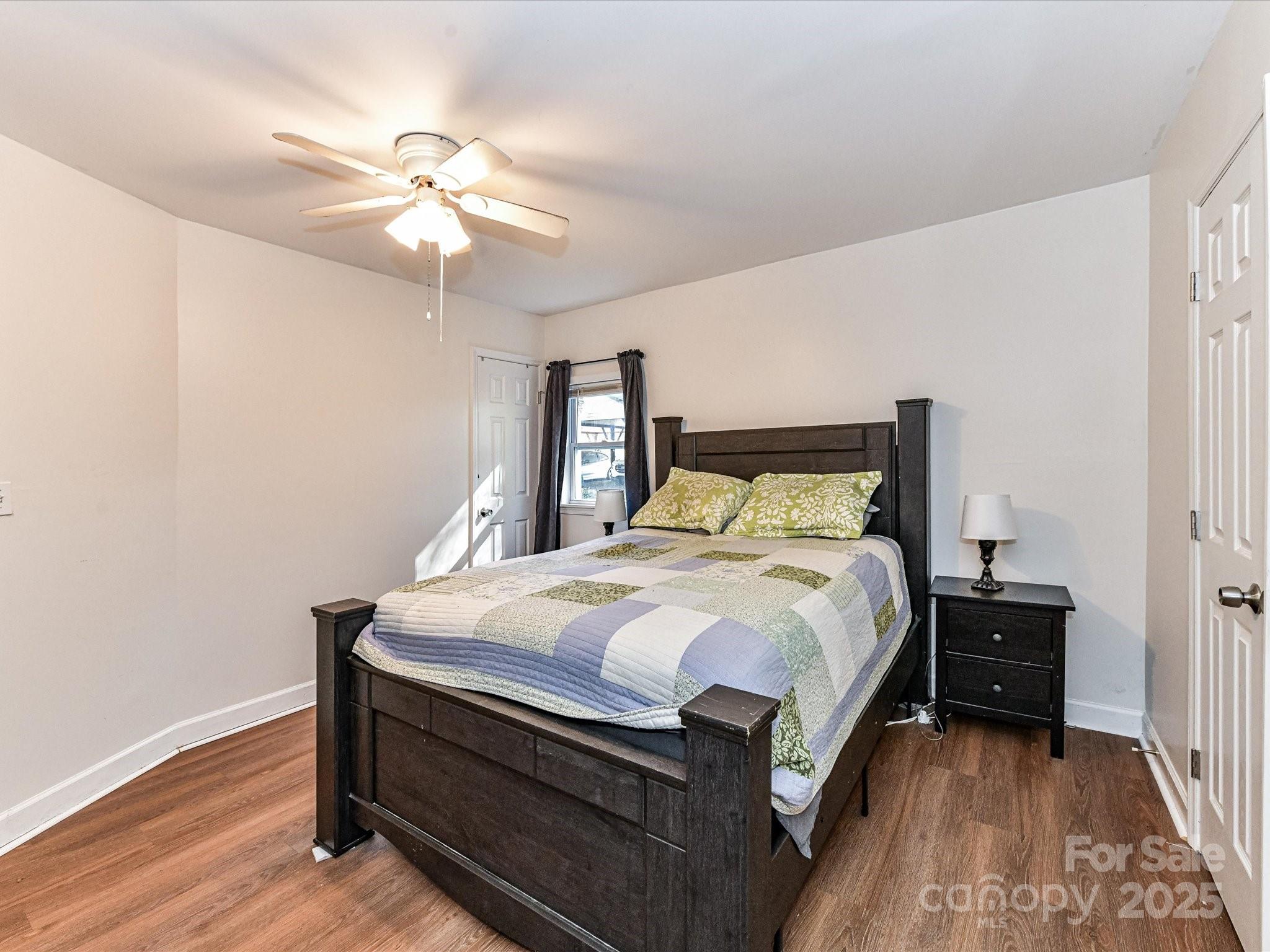 1620 Blueberry Street Mount Pleasant, NC 28124 - Photo 18 of 31 a bedroom with a bed and a chandelier