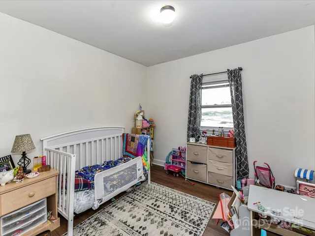a bedroom with furniture and a window