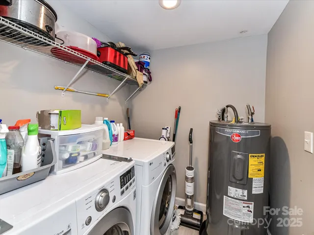 a utility room with dryer washer and a wooden floors
