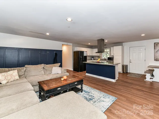 a living room with furniture and kitchen view