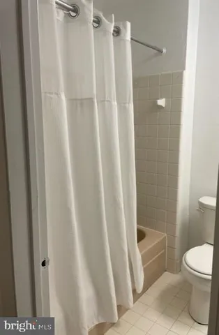 a bathroom with a shower and a toilet