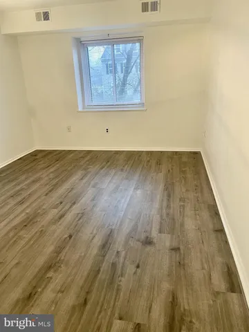 an empty room with wooden floor