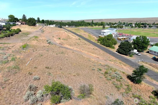 a view of a lake with beach and city space