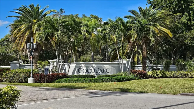 a sign board with tall buildings