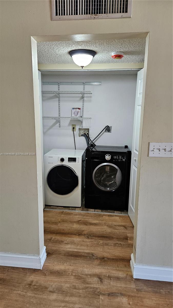 801 Lyons Road, Unit 19203 Coconut Creek, FL 33063 - Photo 14 of 28 a utility room with dryer and washer