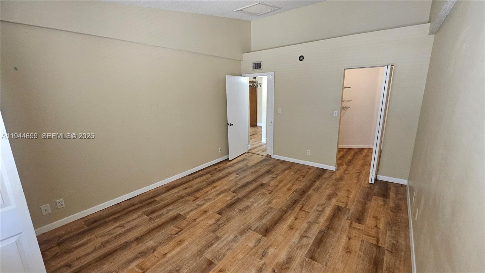 801 Lyons Road, Unit 19203 Coconut Creek, FL 33063 - Photo 19 of 28 a view of a room with wooden floor and bench