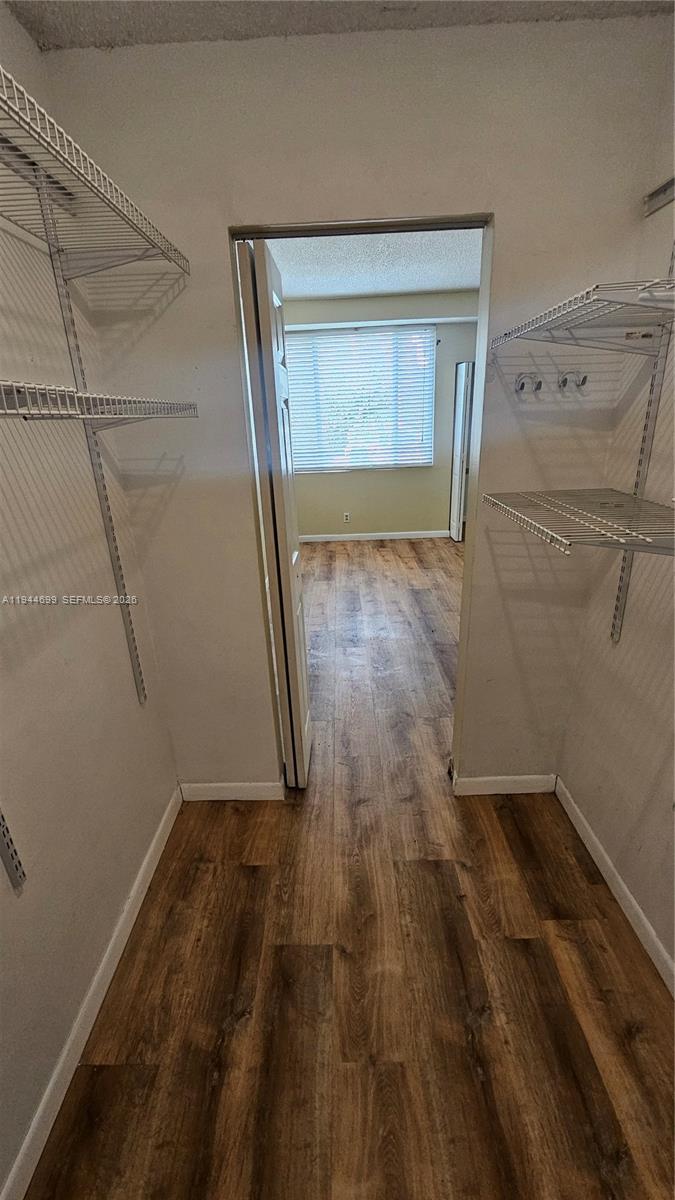 801 Lyons Road, Unit 19203 Coconut Creek, FL 33063 - Photo 20 of 28 a view of empty room with wooden floor