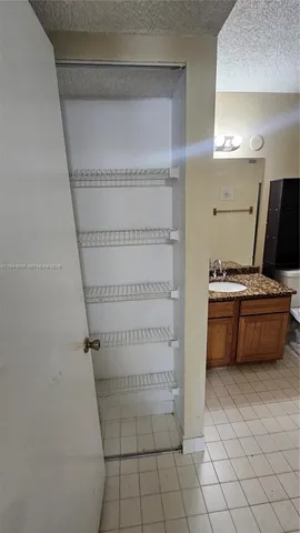 a bathroom with a granite countertop bathtub and toilet