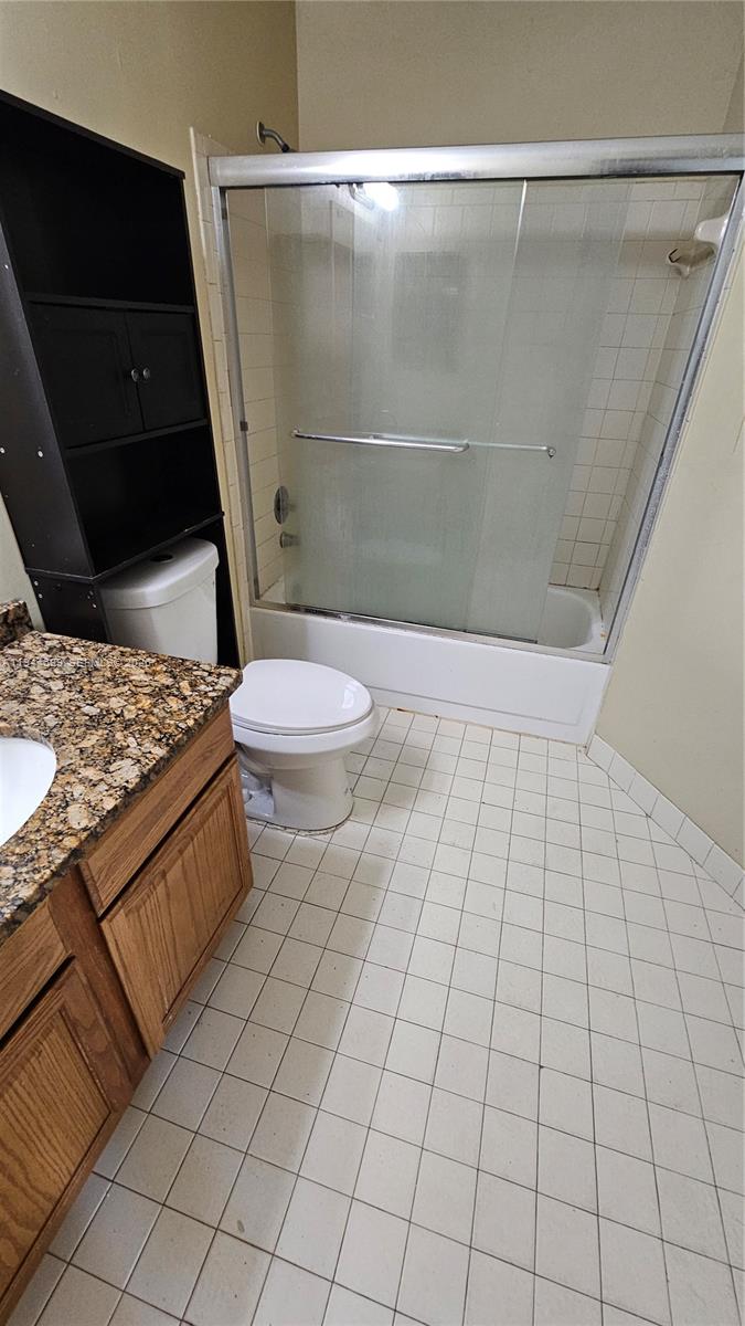 801 Lyons Road, Unit 19203 Coconut Creek, FL 33063 - Photo 24 of 28 a bathroom with a granite countertop bathtub and toilet