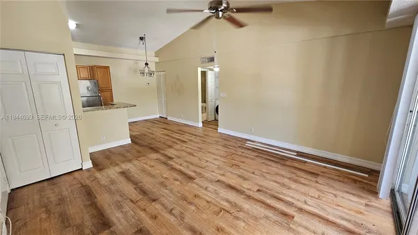 a view of an empty room and a bathroom
