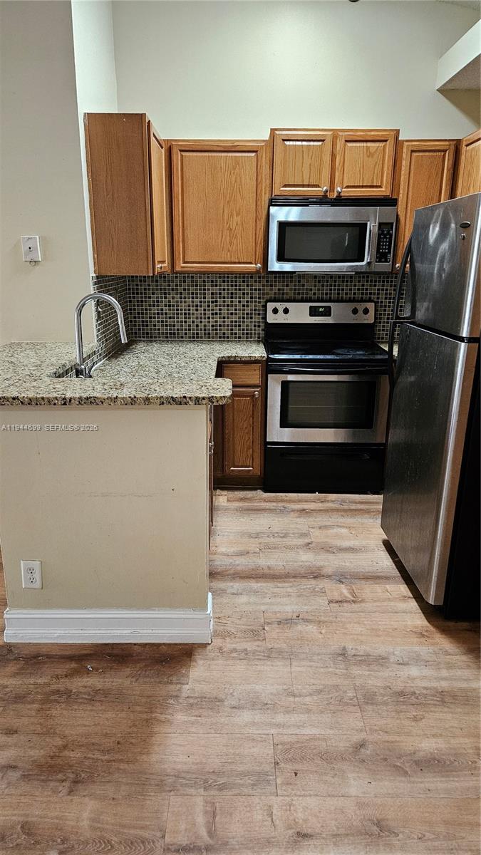 801 Lyons Road, Unit 19203 Coconut Creek, FL 33063 - Photo 10 of 28 a kitchen with granite countertop a stove and a sink