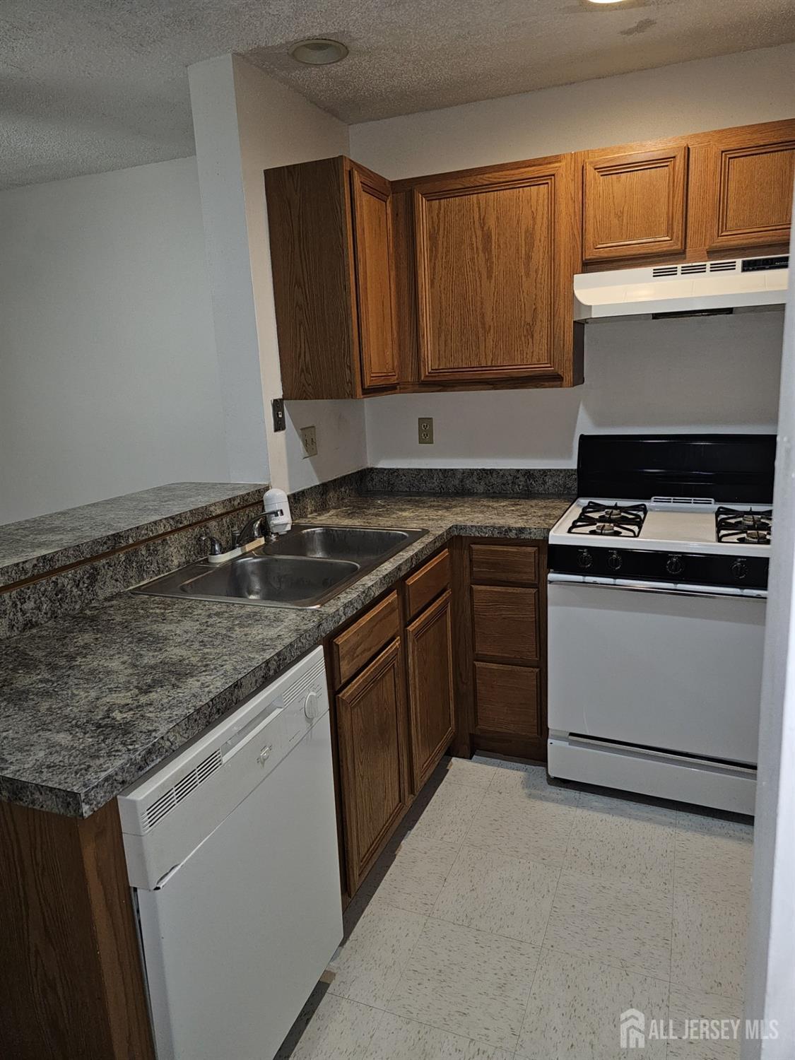 414 Edpas Road New Brunswick, NJ 08901 - Photo 7 of 11 a kitchen with granite countertop a sink stove and cabinets