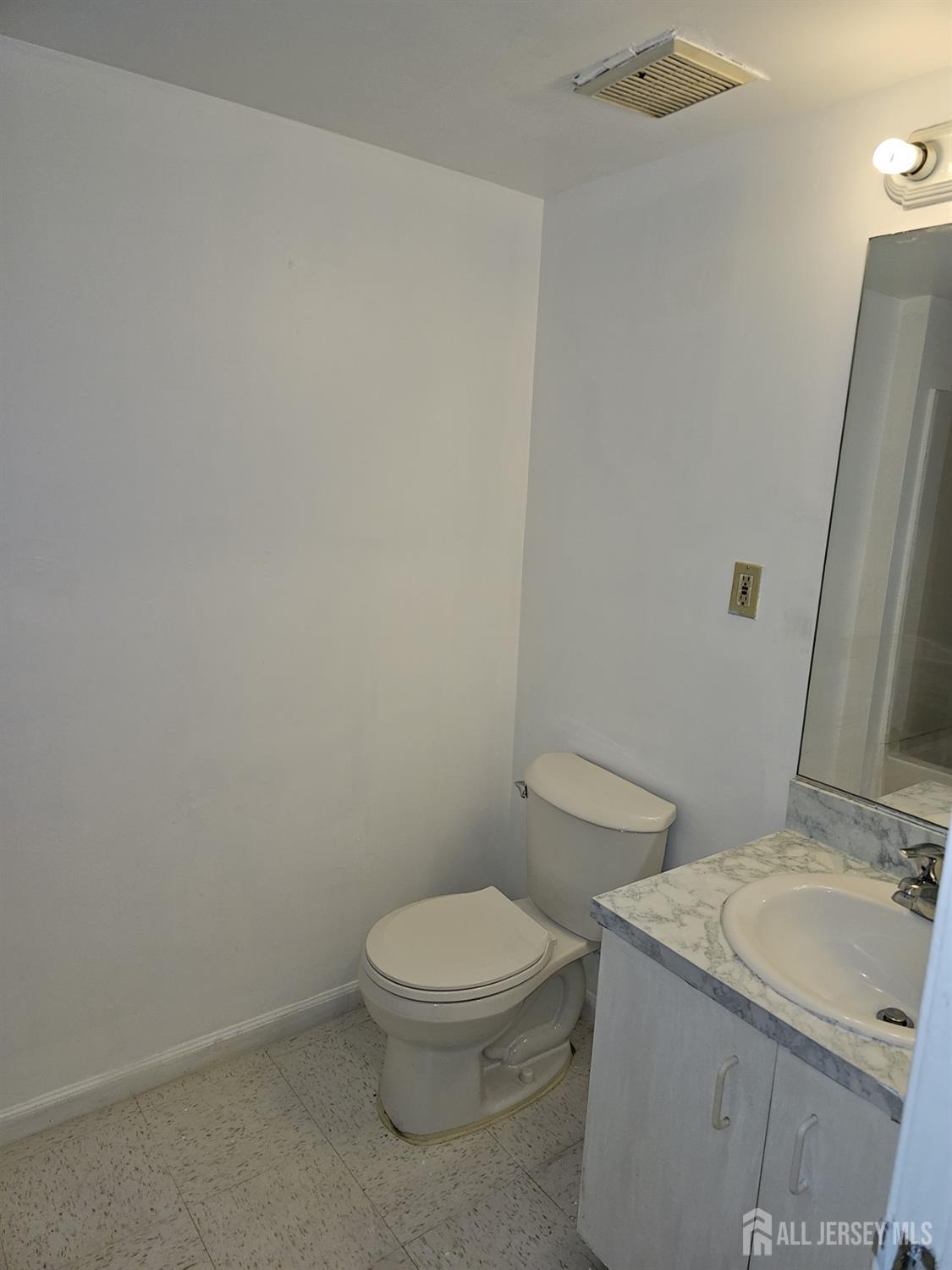 414 Edpas Road New Brunswick, NJ 08901 - Photo 10 of 11 a white toilet sitting next to a bathroom sink