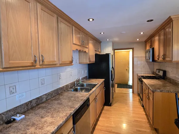 a kitchen with granite countertop cabinets stainless steel appliances a sink and a counter top space
