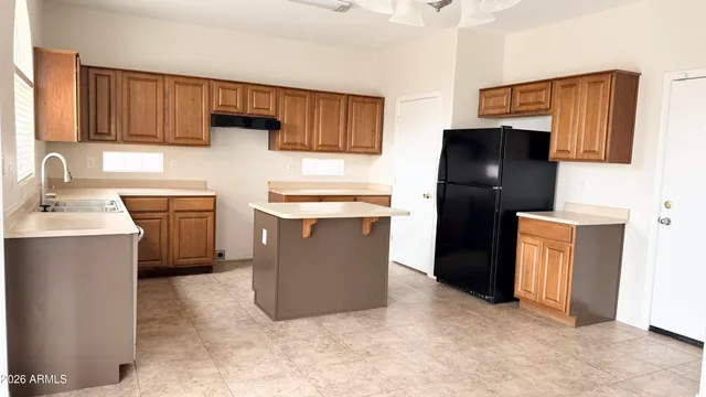 a kitchen with stainless steel appliances a refrigerator and a sink