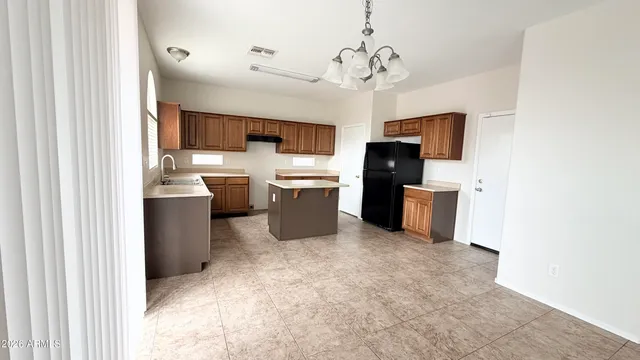 a view of a kitchen with a sink and cabinets