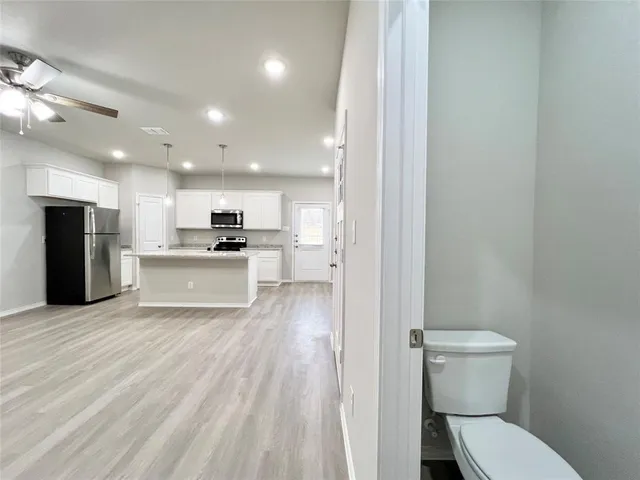 a view of a kitchen with a sink and a toilet