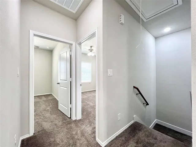 a bathroom with a granite countertop toilet and a sink