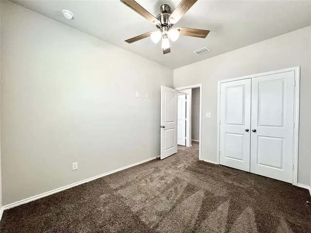 a bathroom with a toilet sink vanity and mirror