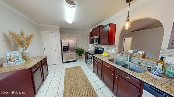 a kitchen with stainless steel appliances granite countertop a stove a sink and a microwave