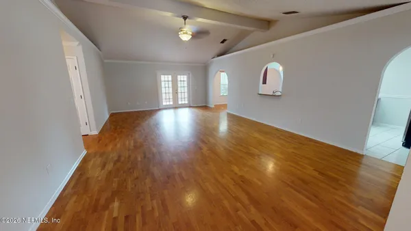 a white bath tub sitting next to a white toilet and a window