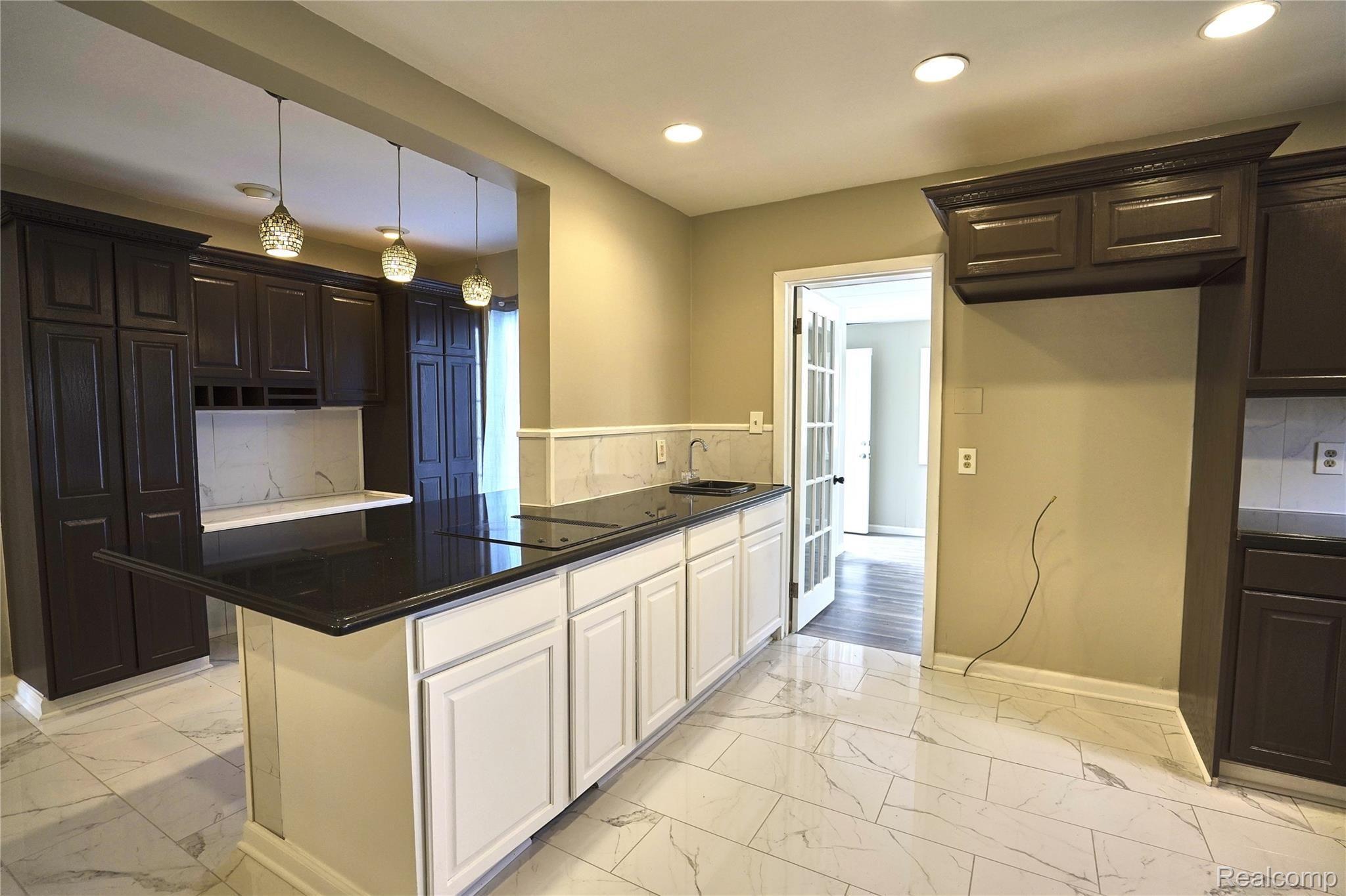 1430 Devonshire Road Grosse Pointe, MI 48230 - Photo 25 of 85 Breakfast bar, built in cooktop, pendant lights, bar sink, pantries and desk area