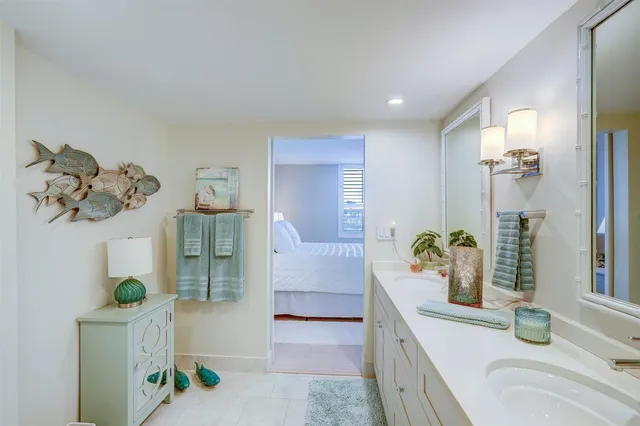 a spacious bathroom with a tub sink and glass door