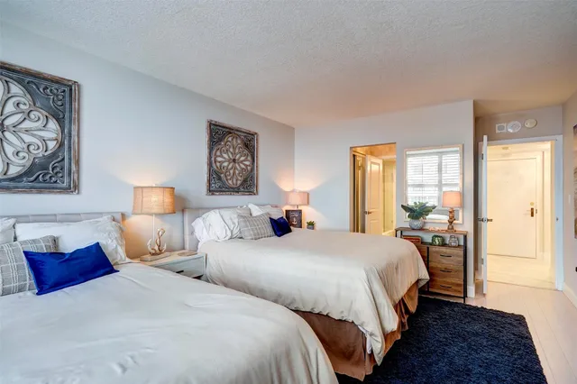 a bedroom with two beds and painting on the wall