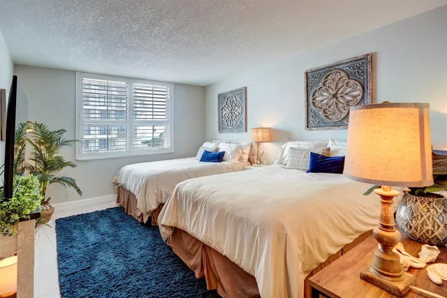 a bedroom with bed and window