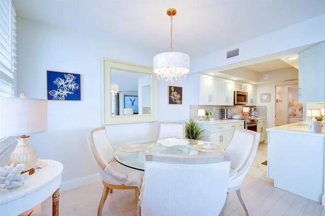 a view of a dining room with furniture and a chandelier