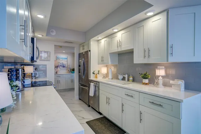 a kitchen with cabinets and window