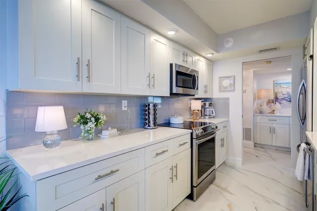 a kitchen with appliances a sink cabinets and a counter top space