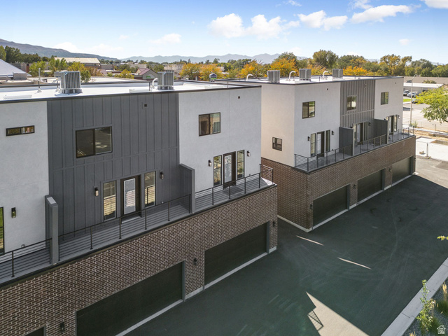 254 North Main Street Bountiful, UT 84010 - Photo 32 of 45 View of building exterior with a garage, a residential view, and a mountain view