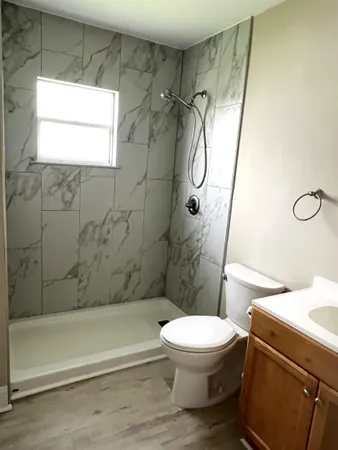 a bathroom with a toilet sink and shower