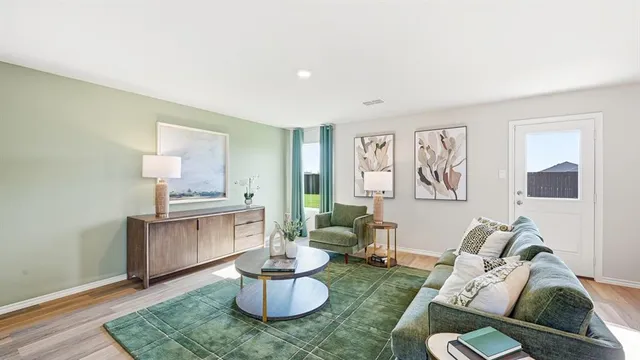a view of a dining room with furniture a potted plant and a mirror
