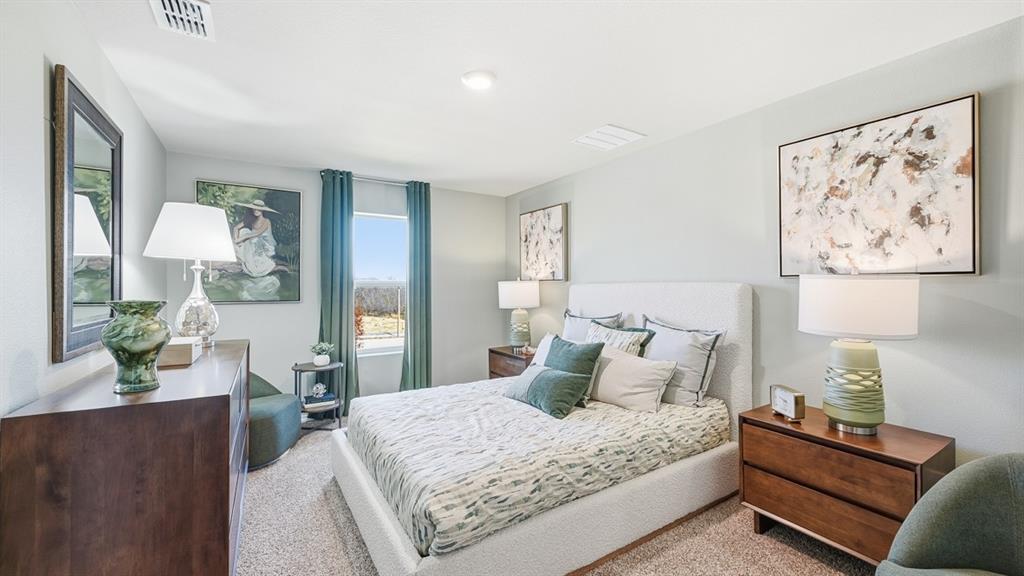 5512 Corduroy Road Krum, TX 76249 - Photo 12 of 38 a bedroom with furniture and a lamp