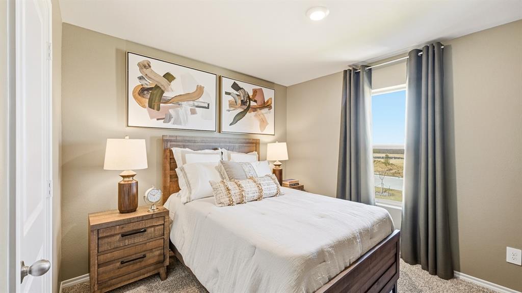 5512 Corduroy Road Krum, TX 76249 - Photo 18 of 38 a bedroom with a bed and a painting on the wall