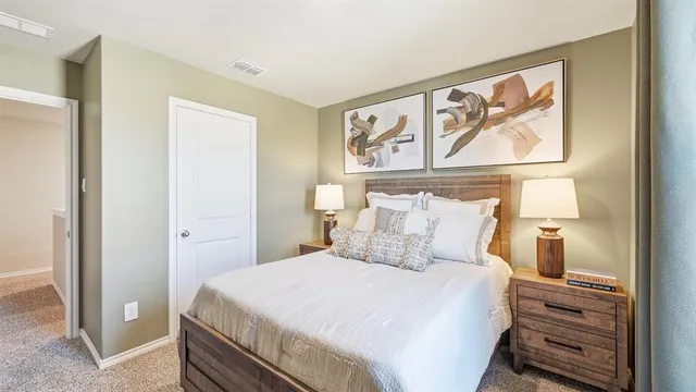 a bedroom with a bed and a painting on the wall