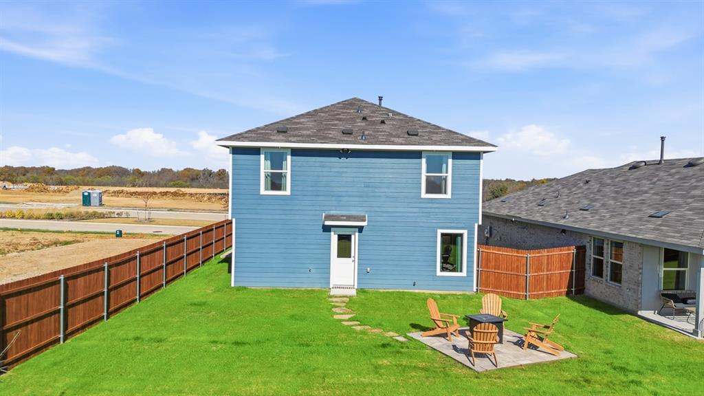 5512 Corduroy Road Krum, TX 76249 - Photo 37 of 38 a view of a house with a yard and sitting area