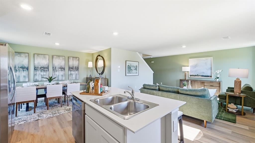 5512 Corduroy Road Krum, TX 76249 - Photo 4 of 38 a kitchen with a sink cabinets and wooden floor