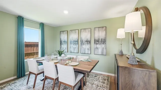 a kitchen with a sink cabinets and wooden floor