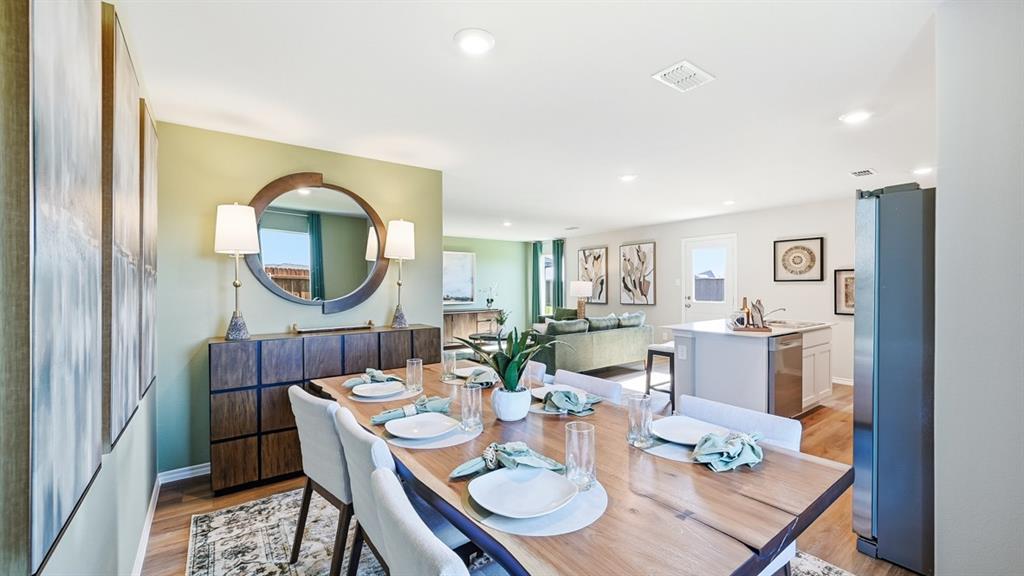 5512 Corduroy Road Krum, TX 76249 - Photo 8 of 38 a dining room with furniture a mirror and a table