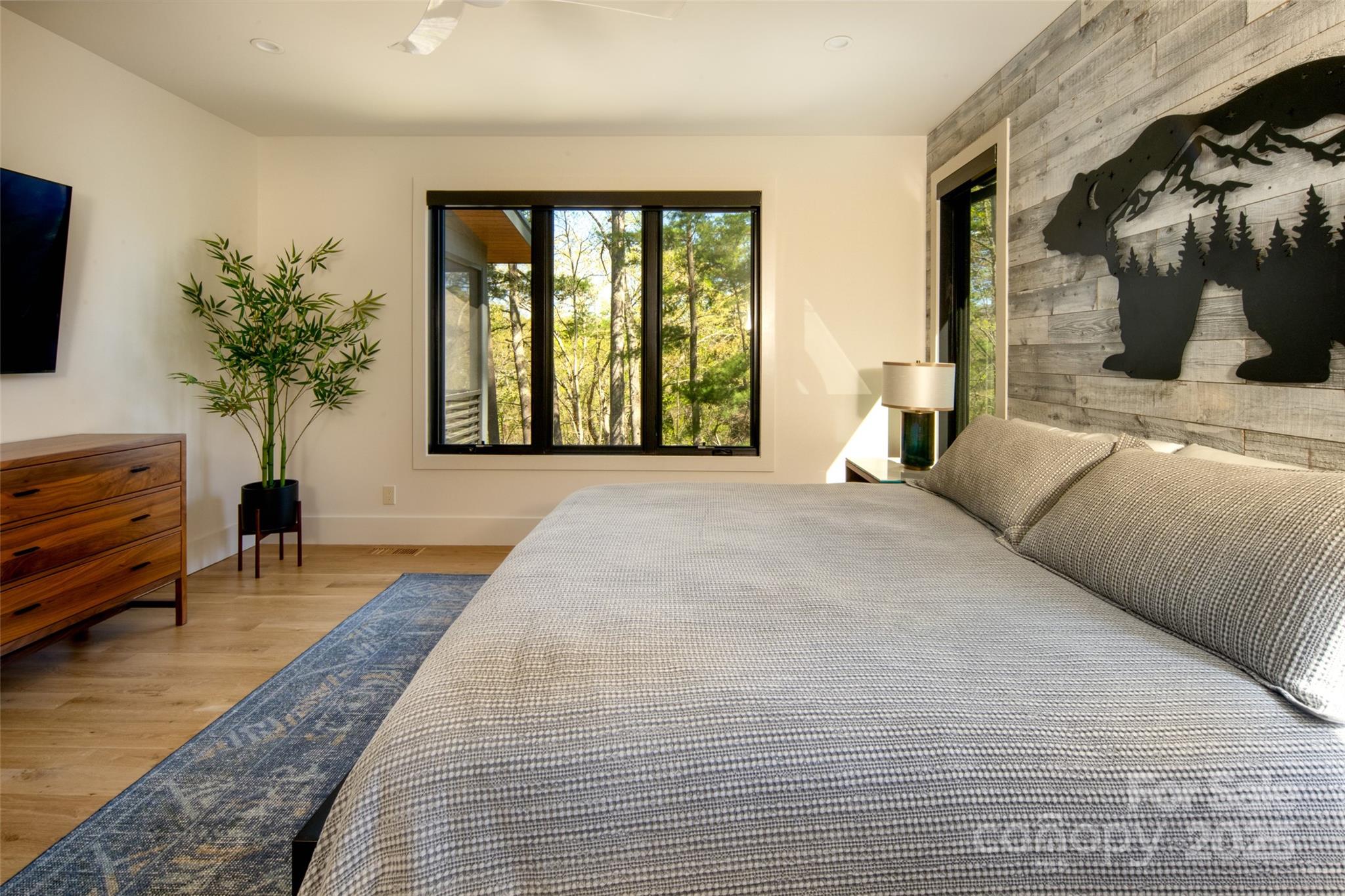 42 Spring Cove Road Asheville, NC 28804 - Photo 20 of 43 a large bedroom with a large bed and a potted plant