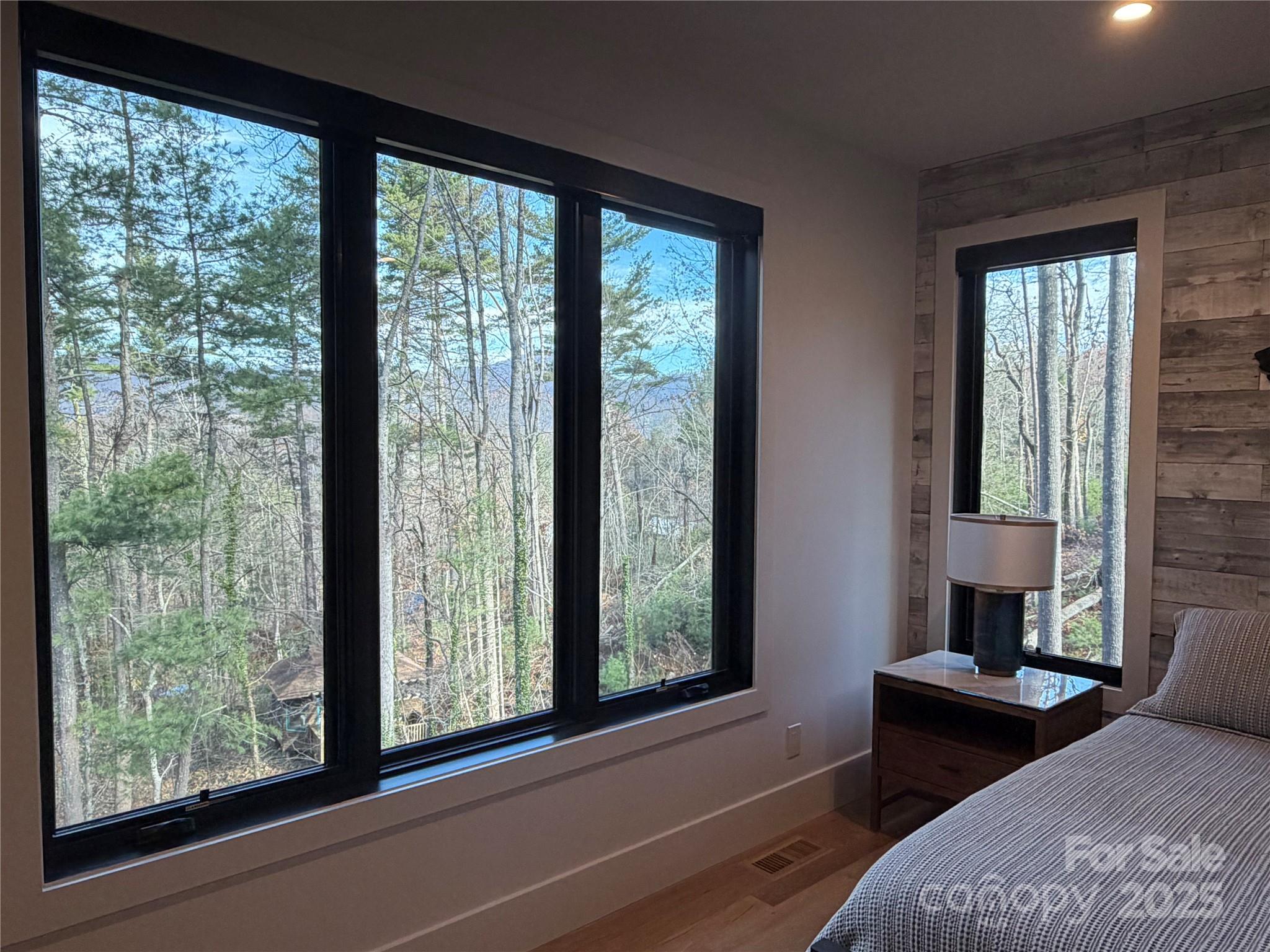 42 Spring Cove Road Asheville, NC 28804 - Photo 21 of 43 a bedroom with a bed and large windows
