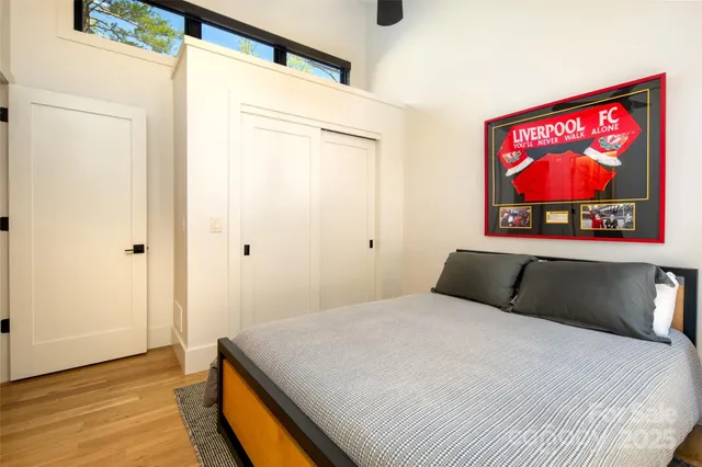 a living room with furniture a flat screen tv and a floor to ceiling window