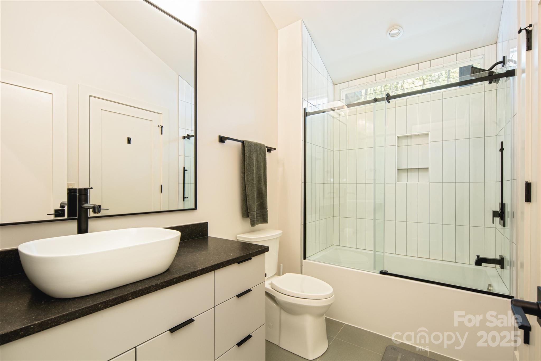 42 Spring Cove Road Asheville, NC 28804 - Photo 29 of 43 a bathroom with a sink toilet a mirror and shower