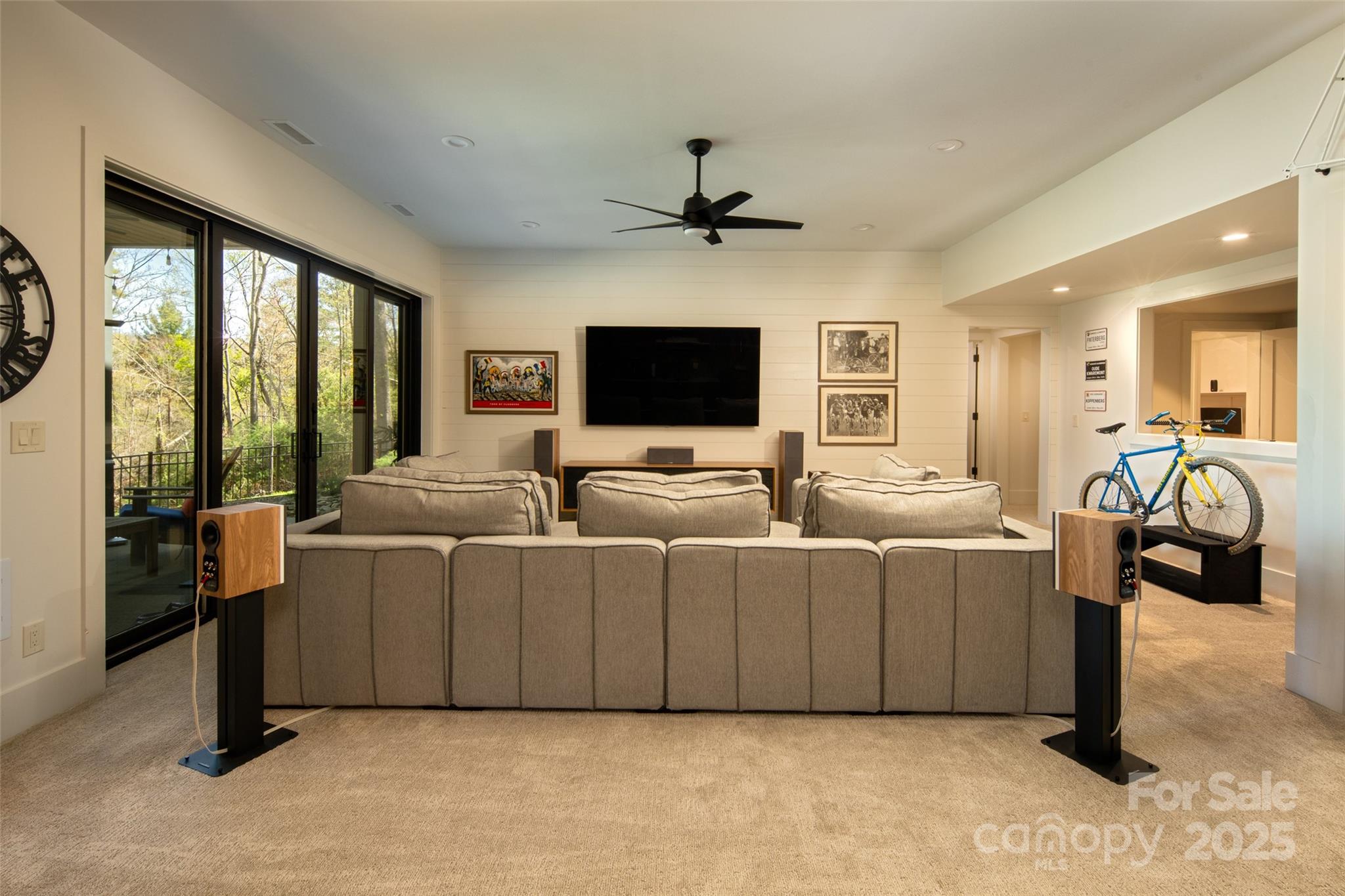 42 Spring Cove Road Asheville, NC 28804 - Photo 37 of 43 a living room with furniture a flat screen tv and a floor to ceiling window