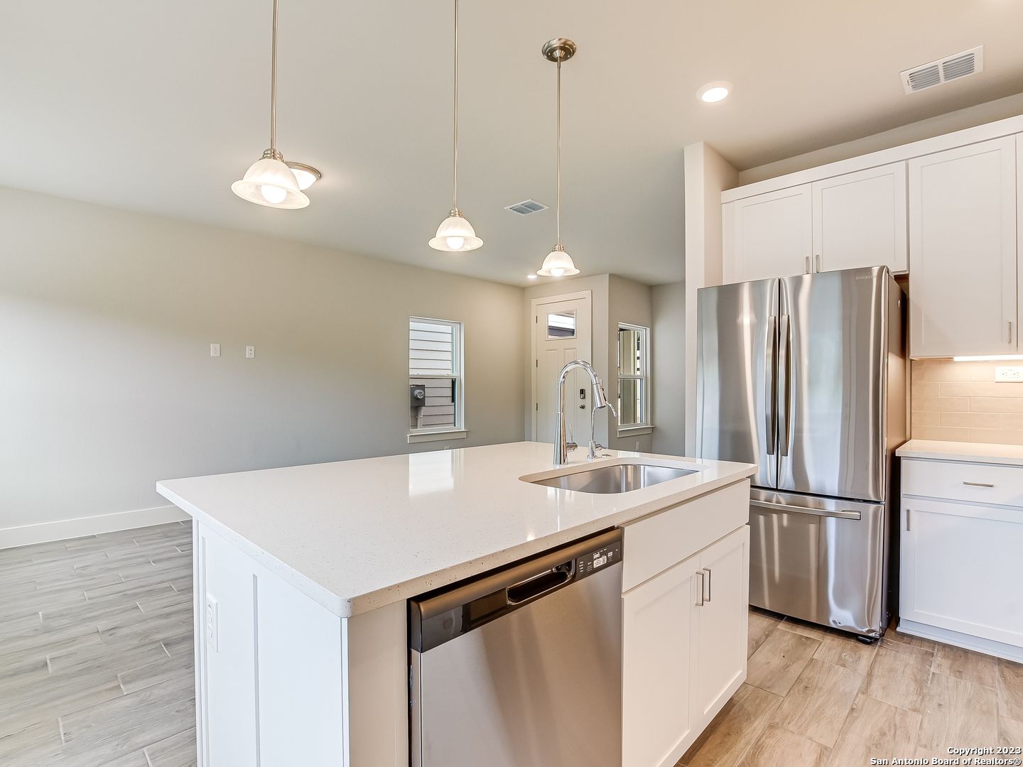 16011 Babcock Road, Unit 22 San Antonio, TX 78255 - Photo 6 of 20 a kitchen with a refrigerator a sink and wooden floor