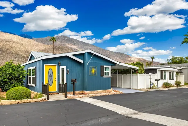 a house with a yard and a kitchen view
