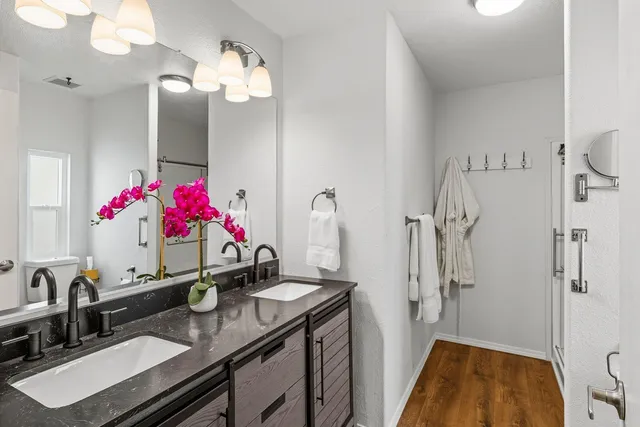 a bathroom with a sink vanity and a mirror